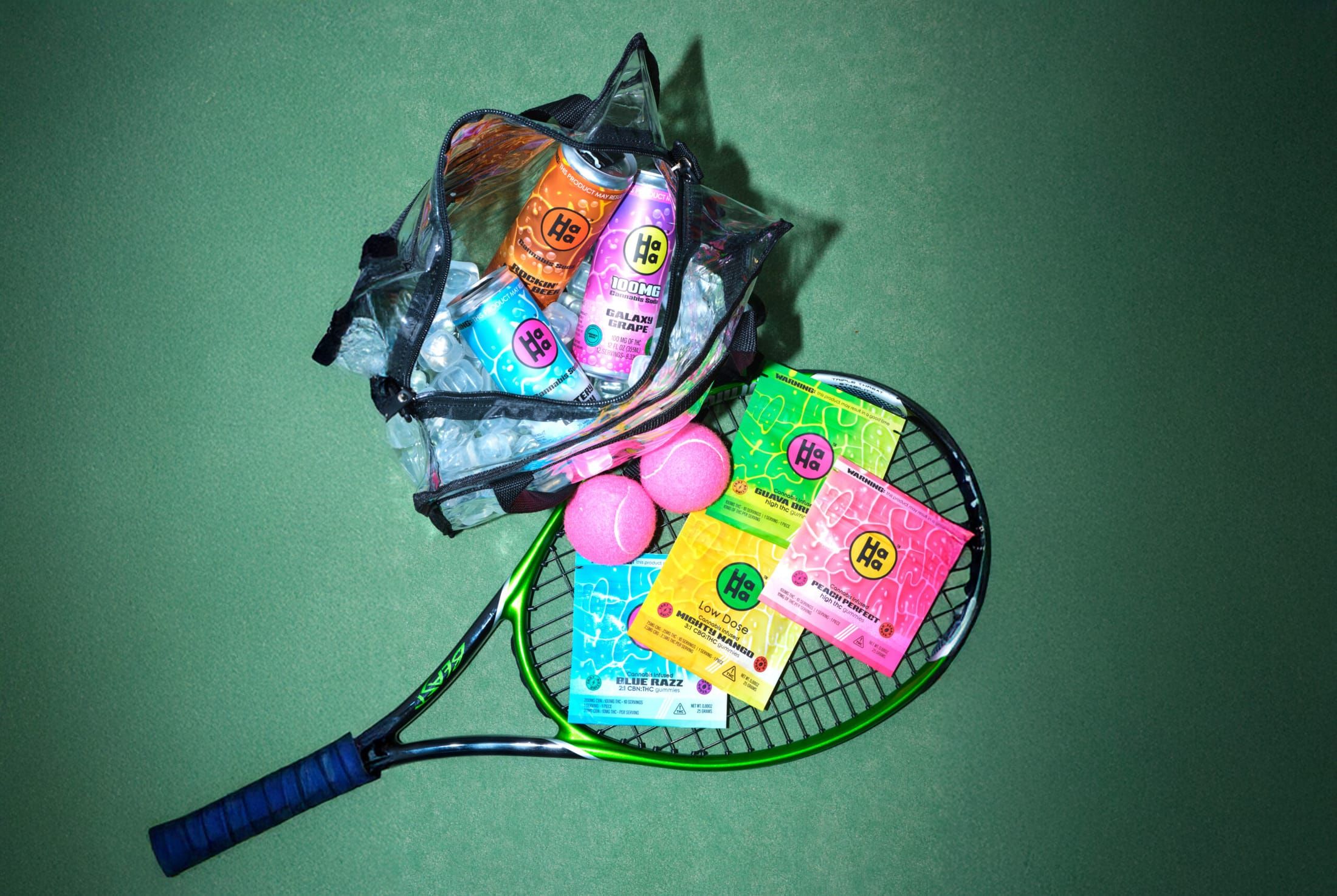 HaHa gummy packs and Bubblies cans piled on a tennis racket